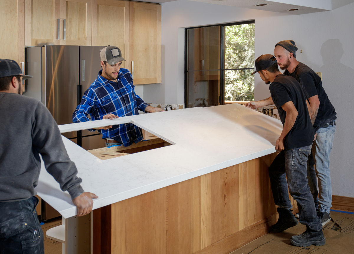 4 contractors installing a kitchen countertop